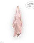Pink towel hanging on a white wall with 'mother's choice' branding.