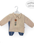 Baby outfit with beige shirt and blue pants on a hanger against a white background, featuring 'mother's choice' branding.