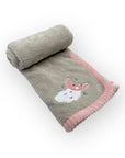 Folded blanket with cartoon fox design on a white background