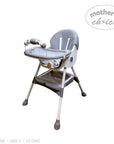 Gray high chair with 'Mother's Choice' branding on a white background