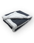 Folded gray and white blanket on a white background