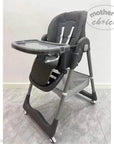 Gray high chair with tray on a light gray floor, branded 'Mother's Choice'.