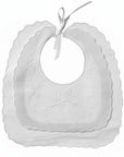Set of white baby bibs with scalloped edges on a white background