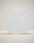 White spherical object with 'ABC' embossed on it against a light background