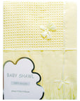 Yellow baby shawl with ribbons on a white background