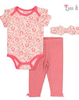 Baby outfit set with bodysuit, pants, and headband featuring pink and white patterns on a white background.