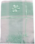 Mint green and white textured blanket with decorative bows on a white background