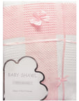 Pink baby shawl with decorative bows on a white background