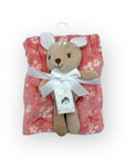 Plush teddy bear with a pink floral blanket on a white background