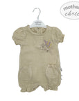 Beige baby romper with floral design on a hanger against a white background