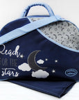 Navy blue baby bag with moon, star, and cloud design, featuring 'Reach for the stars' text, on a white background.