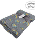 Folded blanket with rainbow pattern and 'Mother's Choice' tag on a white background
