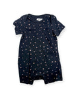 Navy blue baby romper with pink polka dots on a white background
