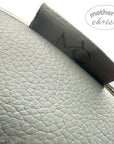Close-up of a textured fabric with 'mother's choice' branding on a light gray background.