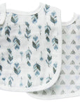 Two baby bibs with feather and triangle patterns on a white background