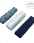 Three rolled-up towels in blue, white, and navy with 'Mother's Choice' branding on a white background.