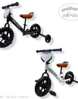Two children's balance bikes, one black and white and the other white with black accents, on a white background.