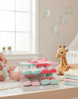 Stork And Baby 4 pack baby socks gift set with bear theme, featuring pink, mint green, and grey socks. Packaged in a clear box with a pink ribbon.
