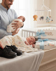 Stork and Baby black faux leather lace-up baby shoes with a classic design, perfect for formal or everyday wear.