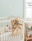 Stork and Baby beige plush blanket with elephant toy and teether, perfect for nursery.
