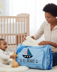 Stork And Baby light blue square diaper bag with 'All Aboard!' boat graphic, multiple compartments, and playful nautical print.