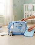 Stork And Baby blue square diaper bag with giraffe embroidery and a changing pad. Includes a stuffed giraffe.