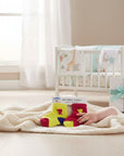 Stork And Baby boys two pack socks, one yellow with red accents and bear, one red with yellow accents and bear.