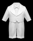 Stork And Baby white christening suit for boys featuring a long-sleeve jacket with tailpiece, bow tie, and shorts.