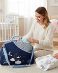 Stork And Baby navy blue diaper bag with moon and stars design, round top opening, and light blue accents.