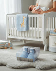 Stork And Baby blue baby socks with dinosaur pattern, cotton blend, in gift box packaging.