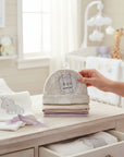 Stork And Baby 4 pack infant beanies in neutral floral print, beige, cream, and lavender.