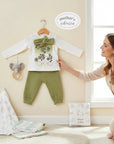 Stork And Baby white long-sleeve top with floral Tokyo graphic and green textured pants. Includes green bow detail.