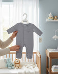 Stork And Baby grey cotton babygrow with footies and snap closure, featuring a subtle embroidered cotton motif.