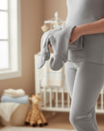 Stork And Baby grey 100% cotton maternity leggings and a baby onesie tied with a ribbon.