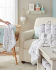 Stork And Baby 6-piece baby bath set with hooded towels and facecloths featuring a 'Hello Little One' animal print.