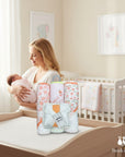 Stork And Baby 6-piece baby hooded towel and facecloth set with peach and floral prints. Soft, absorbent cotton for baby care.