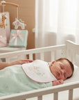 Stork And Baby white cotton dribble bib with pink trim and embroidered unicorn design for infants.