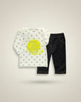 Stork And Baby white long-sleeve top with grey stars and yellow "Shine Bright Little Star" graphic, paired with dark wash stretch denim pants.