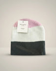 Stork And Baby pink, white, and grey striped knit infants winter hat with a tag.