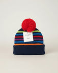Stork And Baby navy knit infants winter hat with multi-colored stripes and red pom-pom.