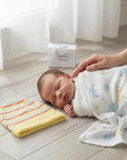 Stork And Baby striped knit infants winter hat in yellow, orange, and blue. Soft and cozy for babies.