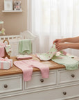 Stork And Baby 8 piece Koala themed newborn gift set with pink pants, green bodysuit, bib, cap, blanket, and washcloths.