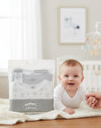 Stork And Baby Mother's Choice 3 pack newborn long sleeve bodysuits in white and grey with subtle patterns.