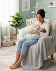 Stork And Baby Mothers Choice white plush polar bear cushion blanket held by a mother with her baby in a nursery.