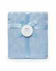 Stork And Baby Mothers Choice light blue knitted baby shawl with cable texture, tied with a matching satin ribbon.