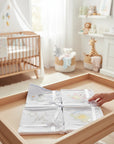 Stork And Baby Mothers Choice cotton jersey baby wraps with cute creature embroidery in a cozy nursery setting.
