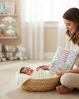 Stork And Baby Mothers Choice flannel baby receivers in nautical prints, held by a mother beside a sleeping newborn.