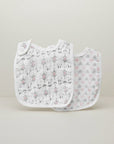 Stork And Baby 2 pack white muslin bibs with grey and pink arrows and hearts pattern. Lightweight and breathable.