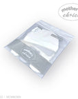 Stork And Baby white newborn hats and mittens 6-piece set in clear packaging. Soft cotton blend for delicate skin.