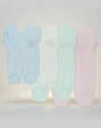 Stork And Baby pastel babygrows in blue, white, mint, and pink. 100% cotton with embroidered airplane, flower, leaves, and butterfly.